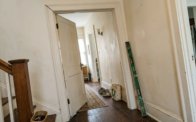 Interior doorway with an out-of-square frame and a visible gap at the top corner